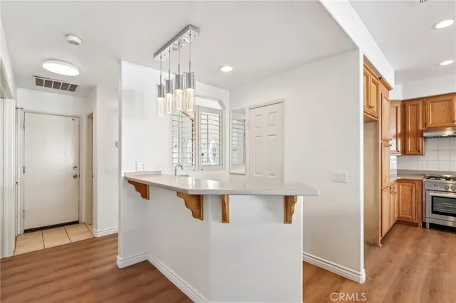a view of kitchen with stainless steel appliances granite countertop a refrigerator and a sink
