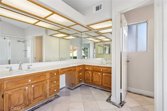 a spacious bathroom with a granite countertop sink mirror and