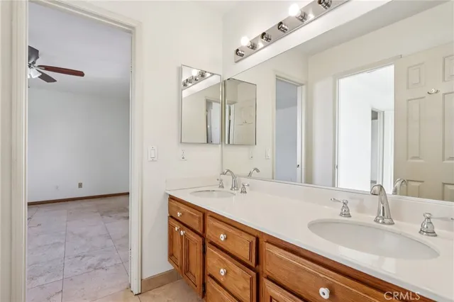 a bathroom with a double vanity sink a mirror and a shower