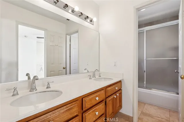a bathroom with a sink double vanity and a mirror