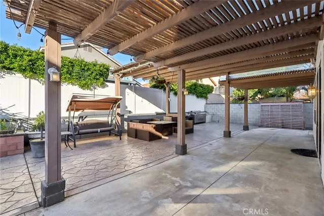 a view of a backyard with table and chairs with wooden floor and fence