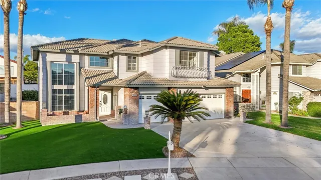 a front view of a house with a garden and patio