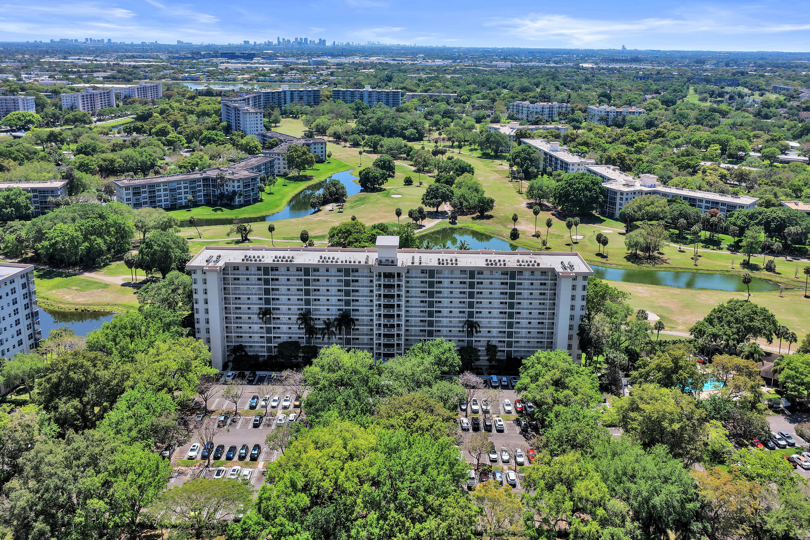 3520 Oaks Way, Unit 1010 Pompano Beach, FL 33069 - Photo 1 of 67 a view of a garden with an ocean view