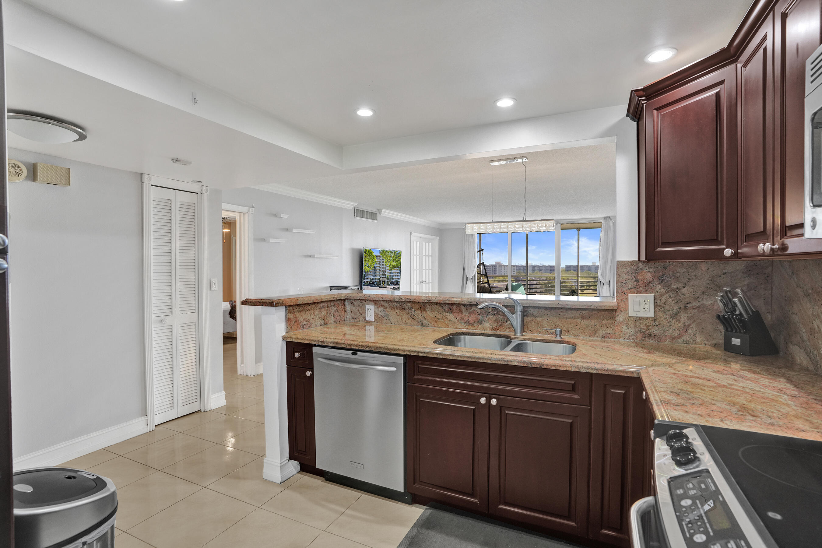 3520 Oaks Way, Unit 1010 Pompano Beach, FL 33069 - Photo 15 of 67 a kitchen with a sink and cabinets