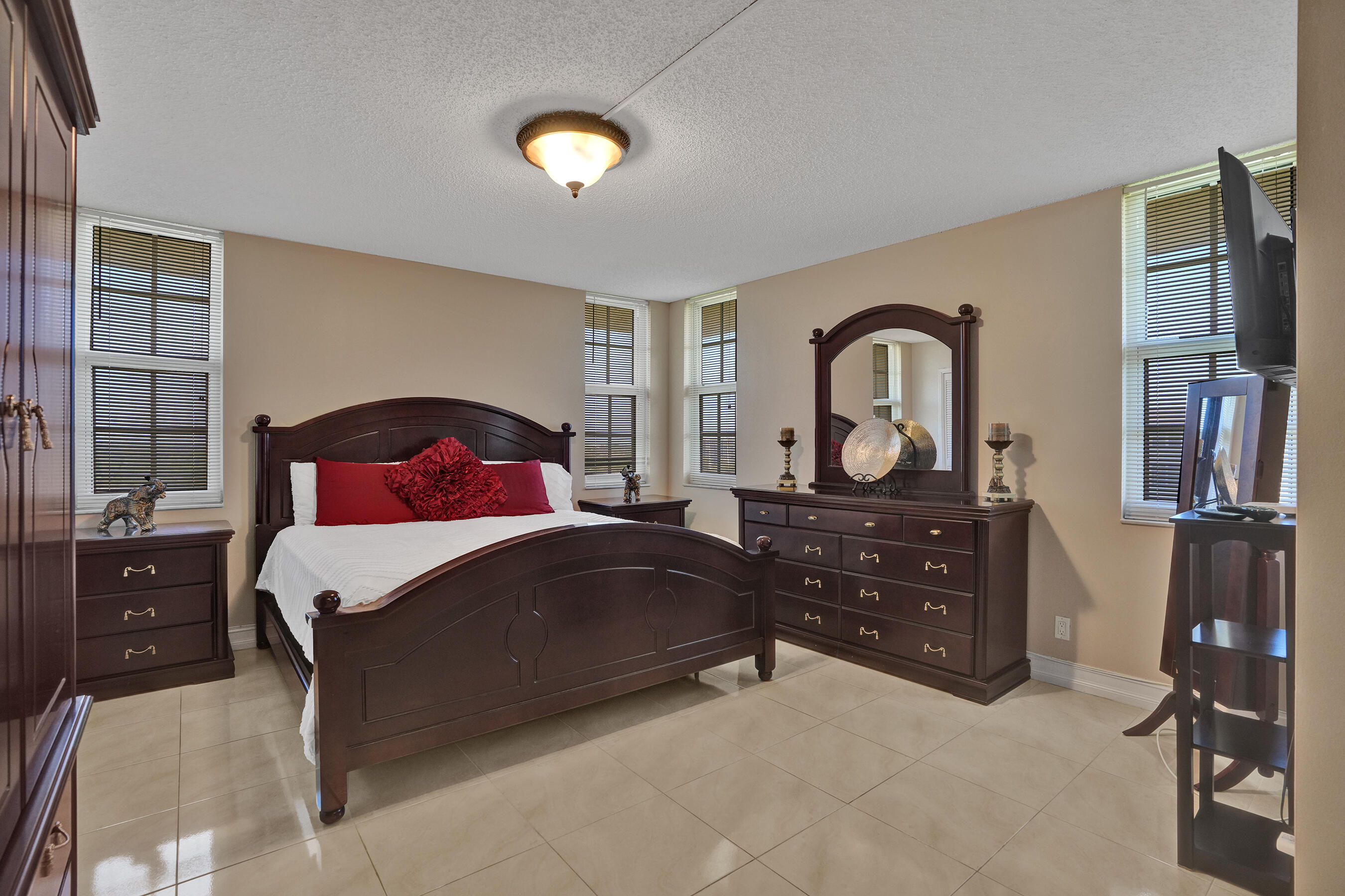 3520 Oaks Way, Unit 1010 Pompano Beach, FL 33069 - Photo 17 of 67 a bedroom with a bed and a dresser