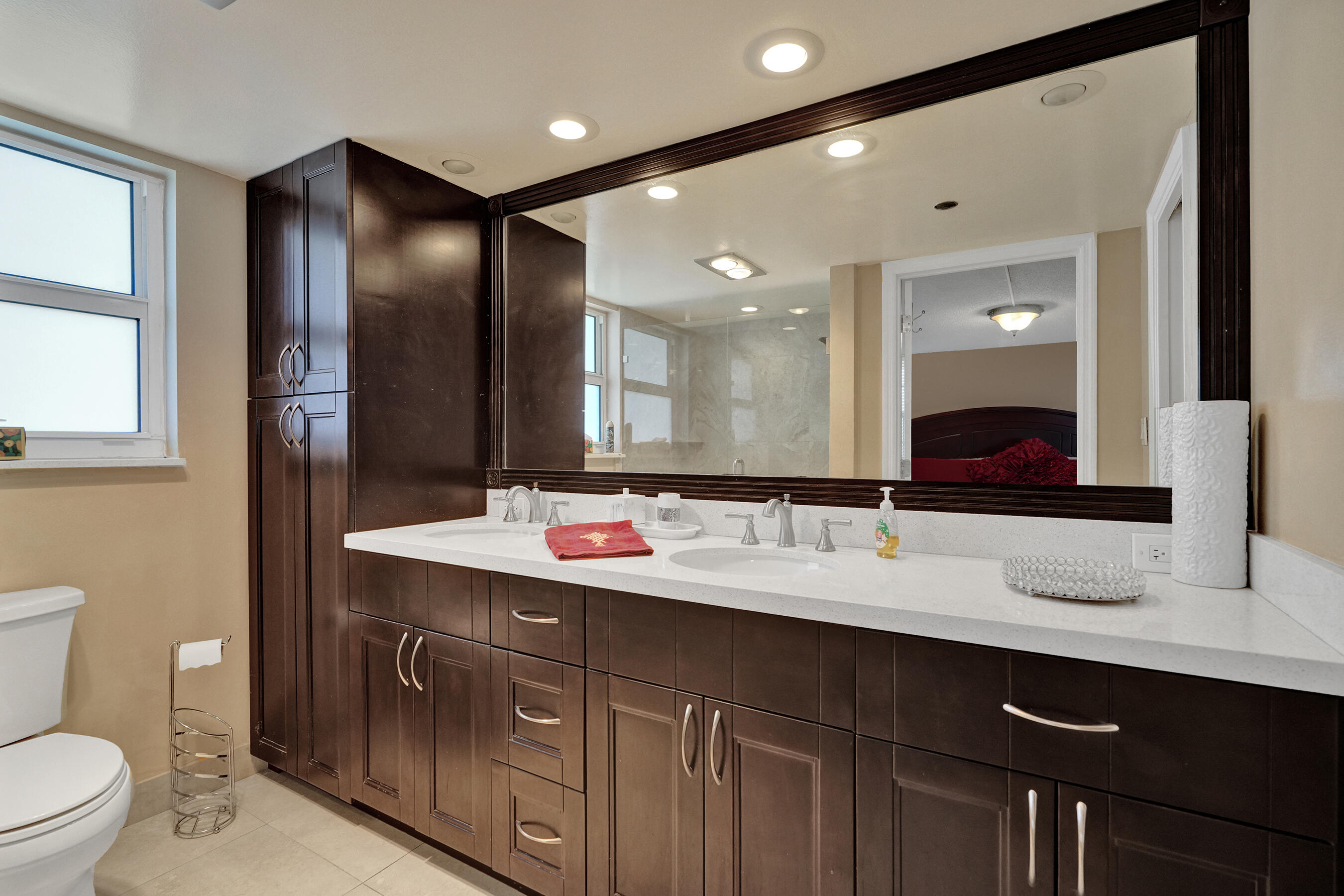 3520 Oaks Way, Unit 1010 Pompano Beach, FL 33069 - Photo 19 of 67 a bathroom with a double vanity sink and a mirror