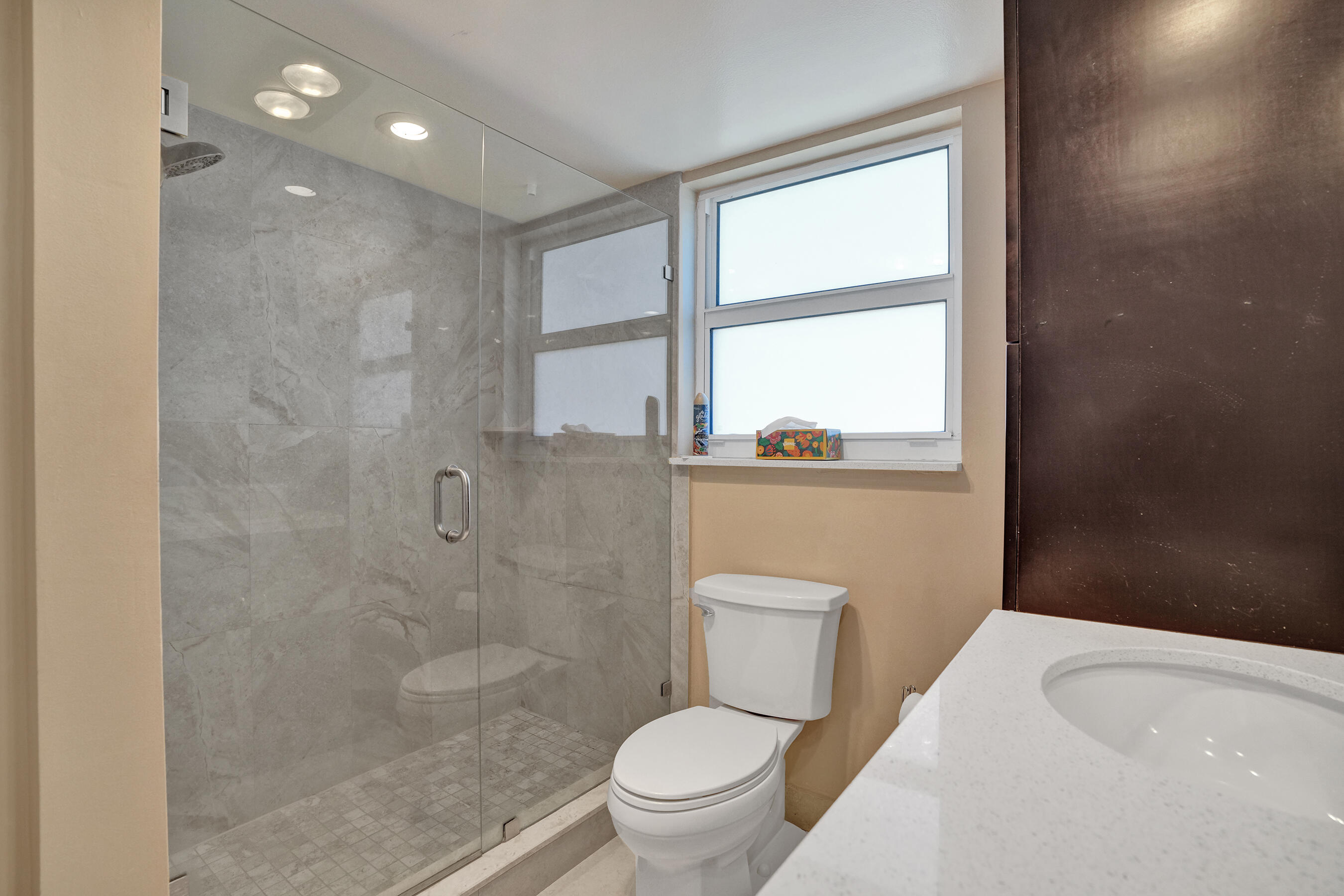 3520 Oaks Way, Unit 1010 Pompano Beach, FL 33069 - Photo 20 of 67 a bathroom with a toilet a sink and a shower