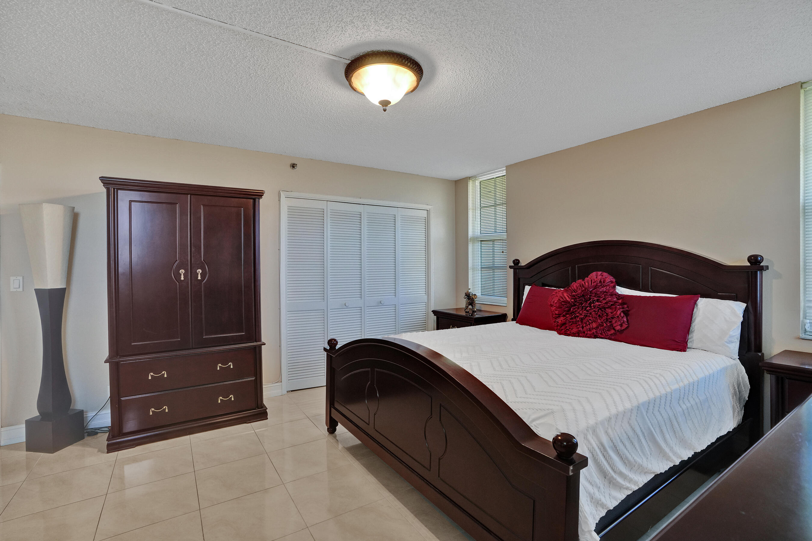 3520 Oaks Way, Unit 1010 Pompano Beach, FL 33069 - Photo 23 of 67 a bedroom with a bed and a closet