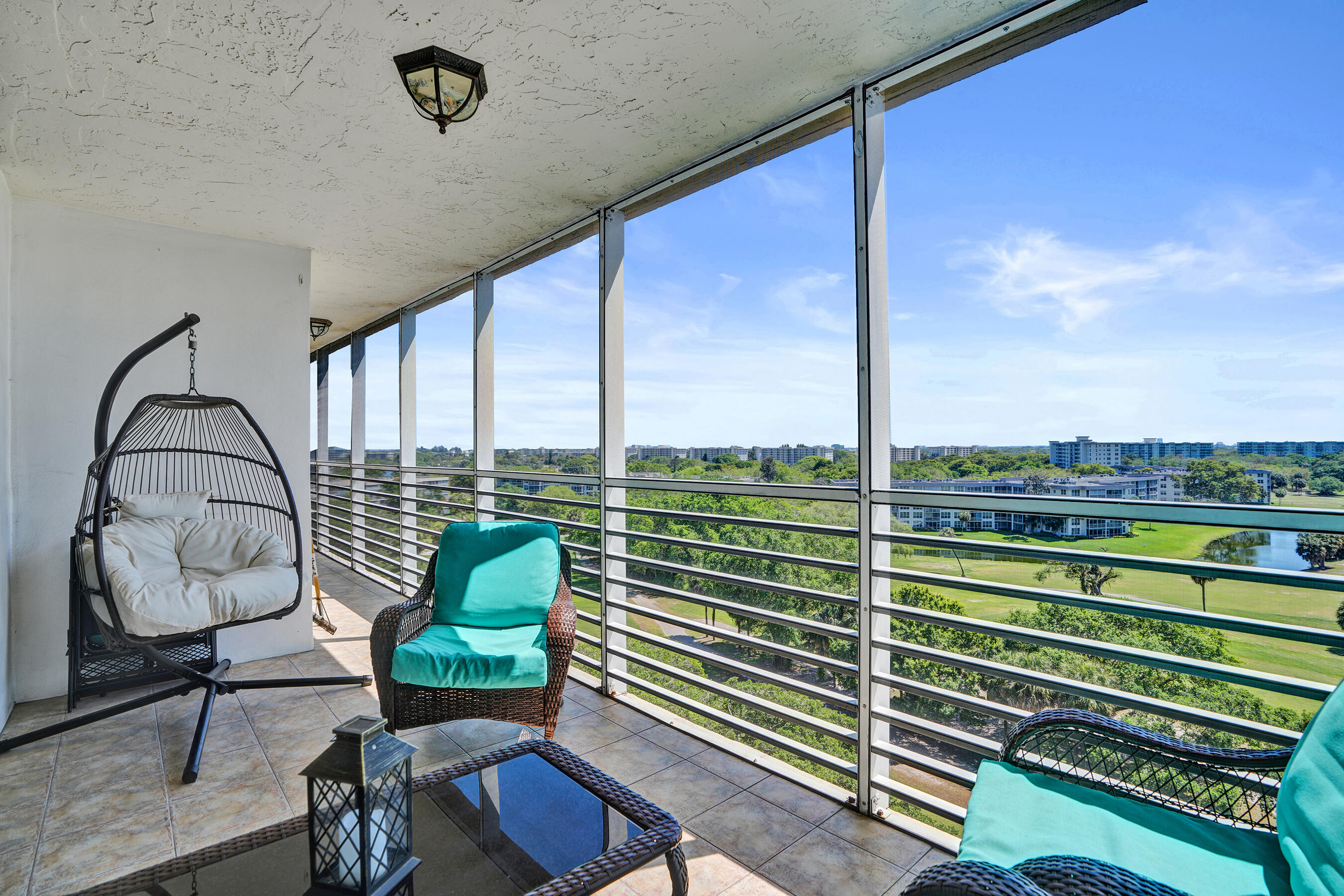 3520 Oaks Way, Unit 1010 Pompano Beach, FL 33069 - Photo 30 of 67 a view of a porch with furniture and a yard
