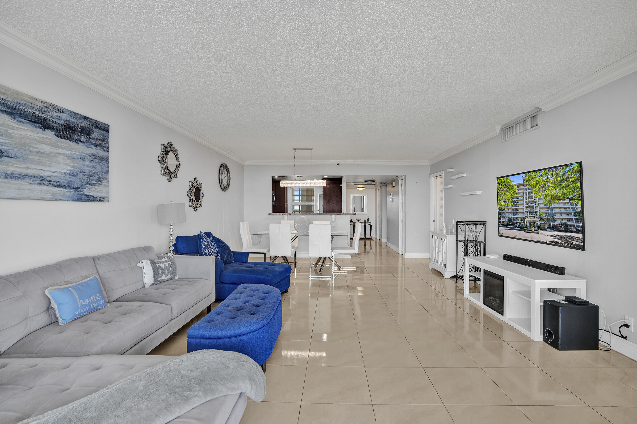 3520 Oaks Way, Unit 1010 Pompano Beach, FL 33069 - Photo 36 of 67 a living room with furniture and a flat screen tv