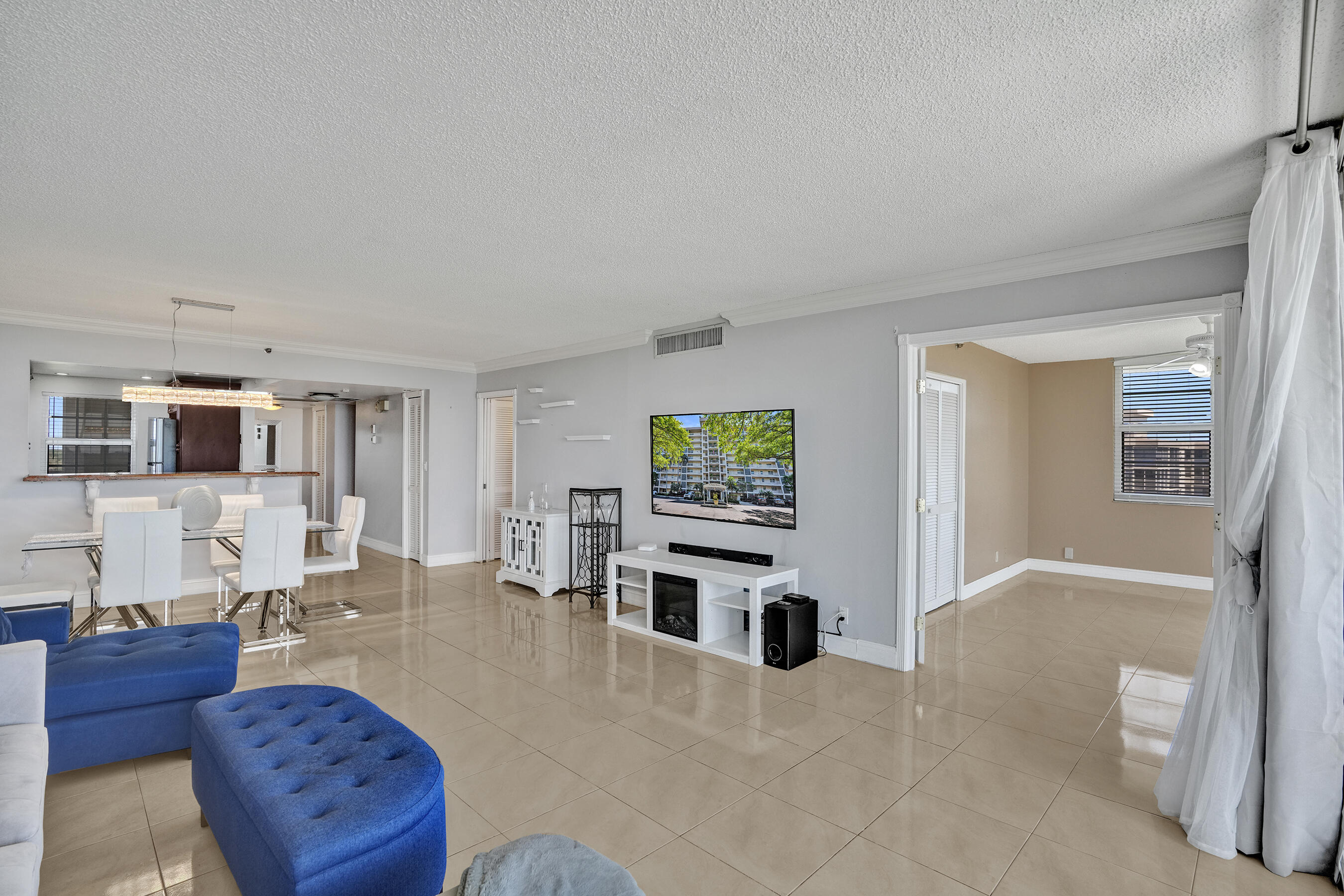 3520 Oaks Way, Unit 1010 Pompano Beach, FL 33069 - Photo 37 of 67 a living room with furniture and a flat screen tv