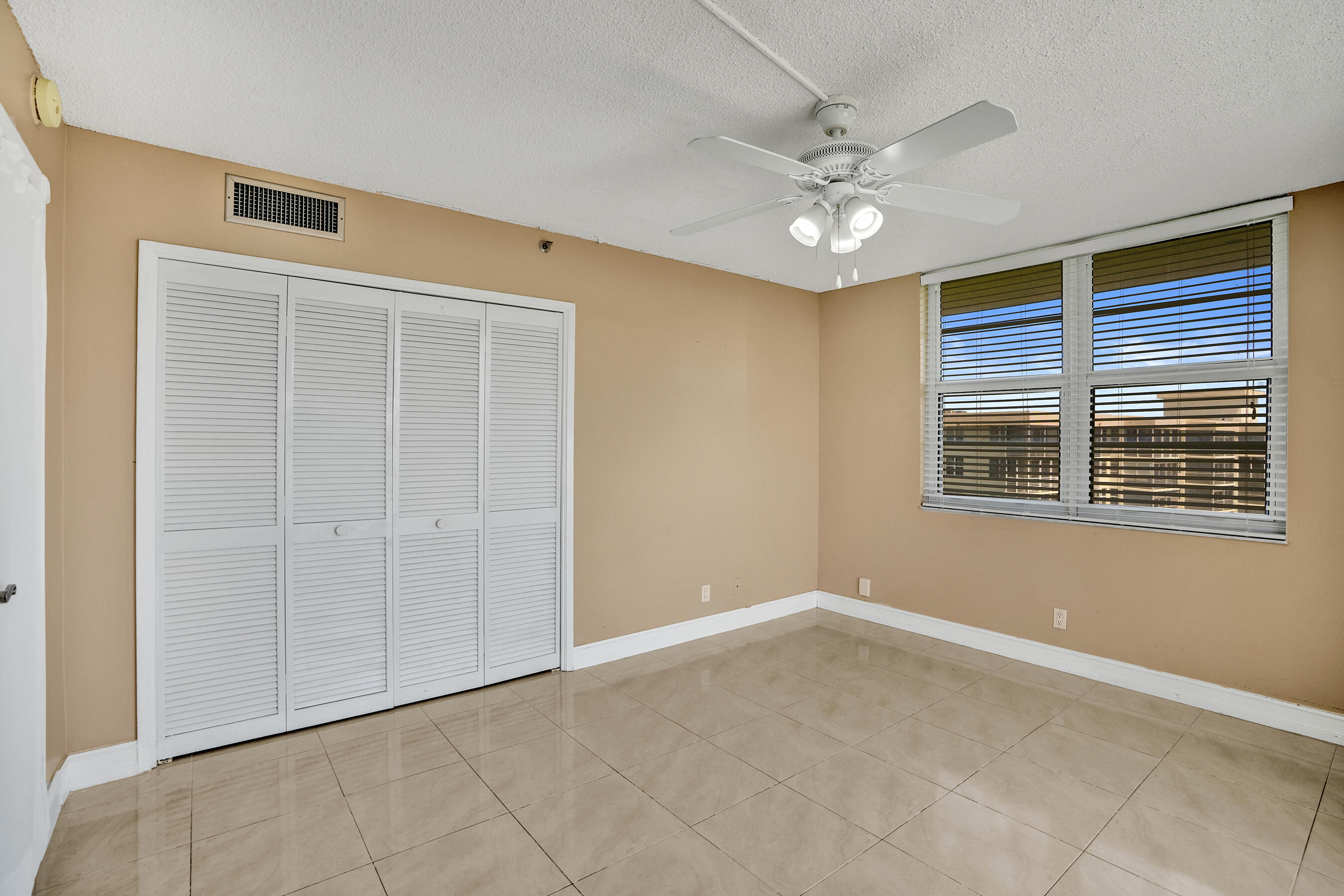 3520 Oaks Way, Unit 1010 Pompano Beach, FL 33069 - Photo 39 of 67 a view of an empty room with a window