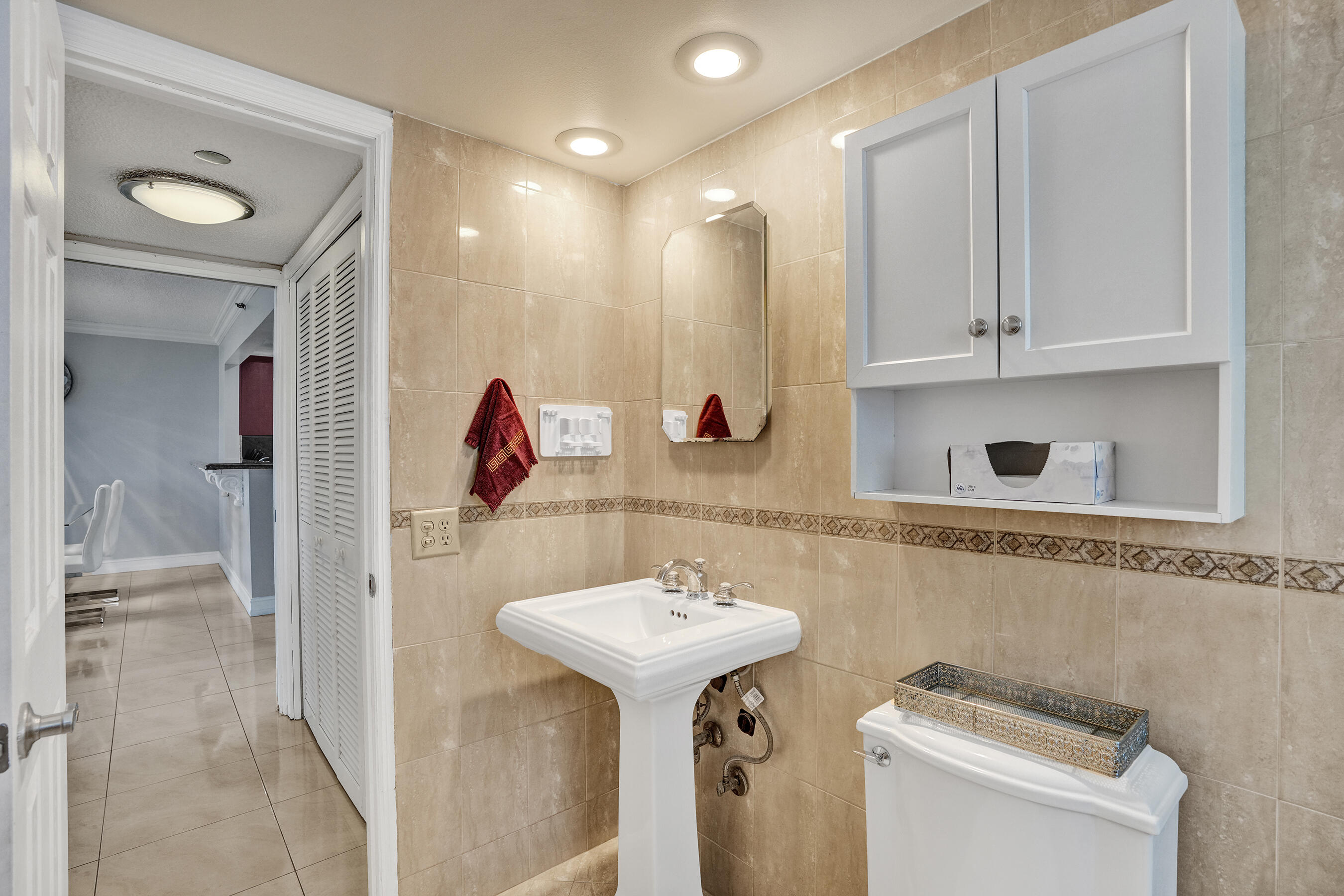 3520 Oaks Way, Unit 1010 Pompano Beach, FL 33069 - Photo 47 of 67 a bathroom with a sink a toilet and shower
