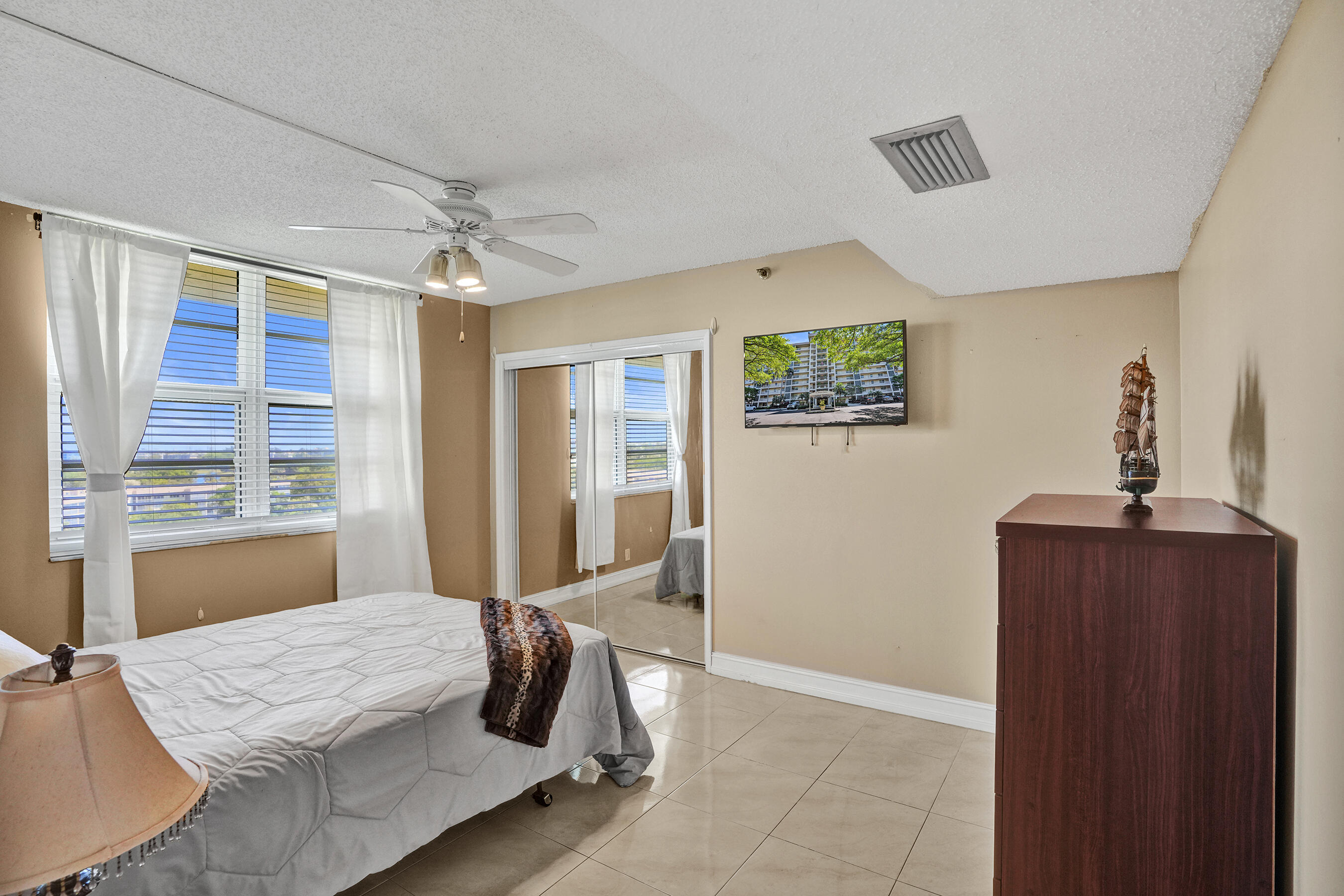 3520 Oaks Way, Unit 1010 Pompano Beach, FL 33069 - Photo 48 of 67 a bedroom with furniture and window