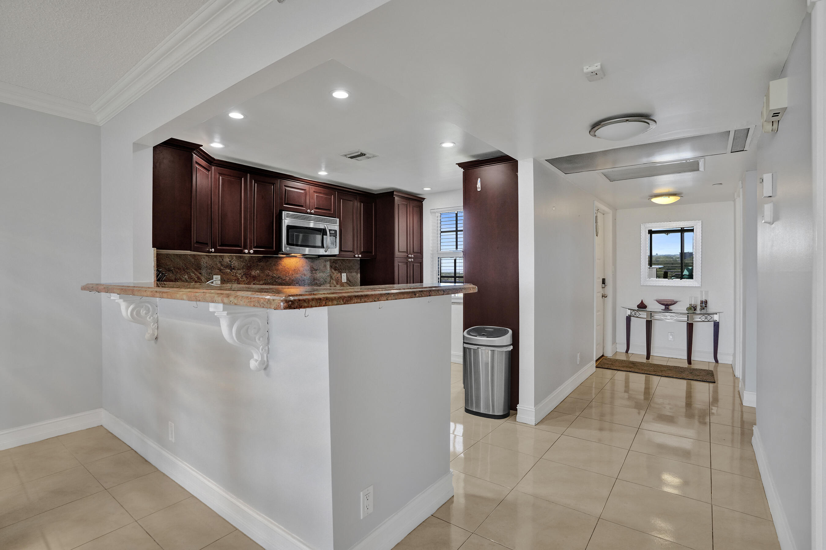 3520 Oaks Way, Unit 1010 Pompano Beach, FL 33069 - Photo 52 of 67 a kitchen with stainless steel appliances granite countertop a refrigerator and a sink