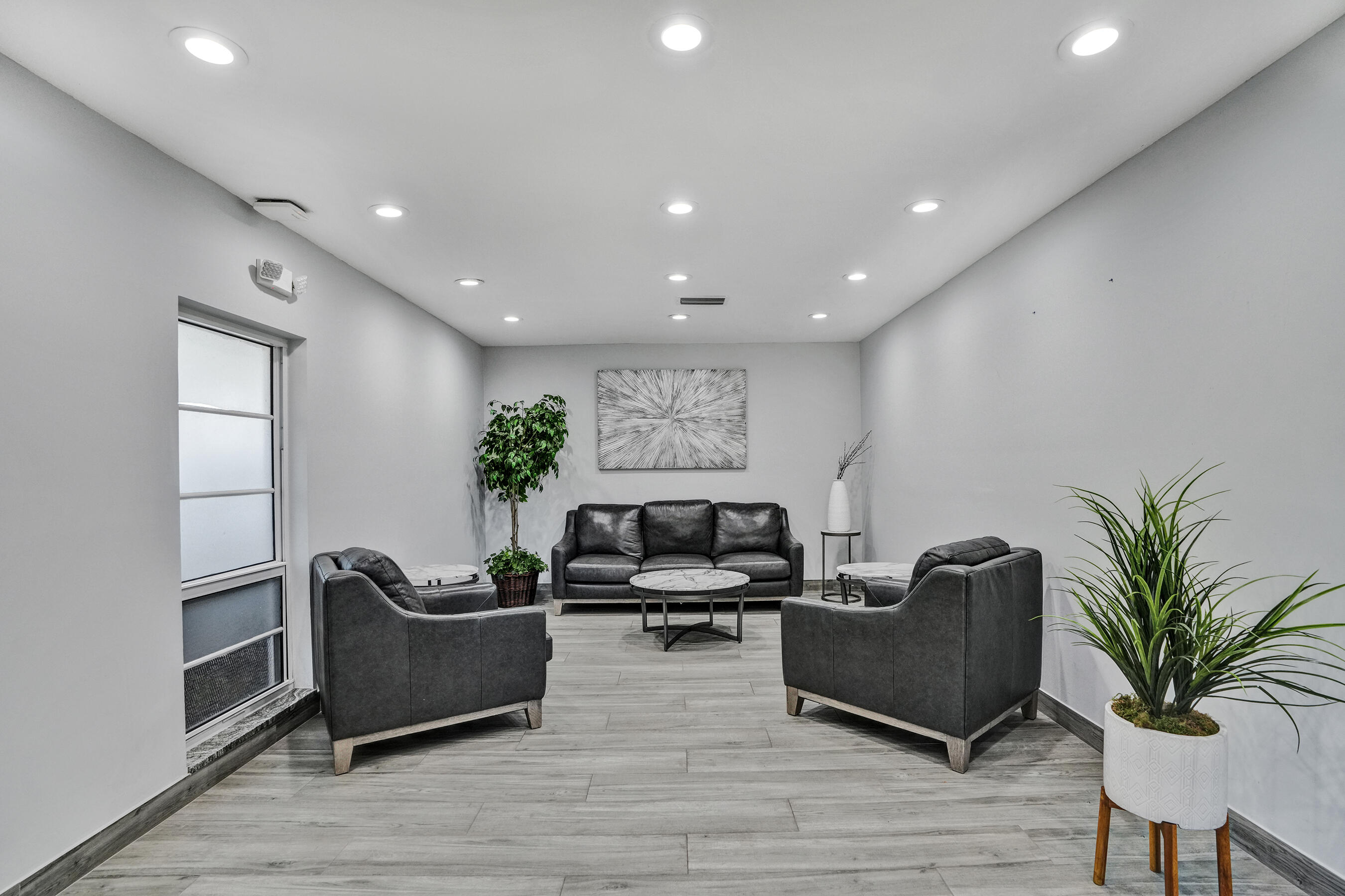 3520 Oaks Way, Unit 1010 Pompano Beach, FL 33069 - Photo 60 of 67 a living room with furniture potted plant and a window