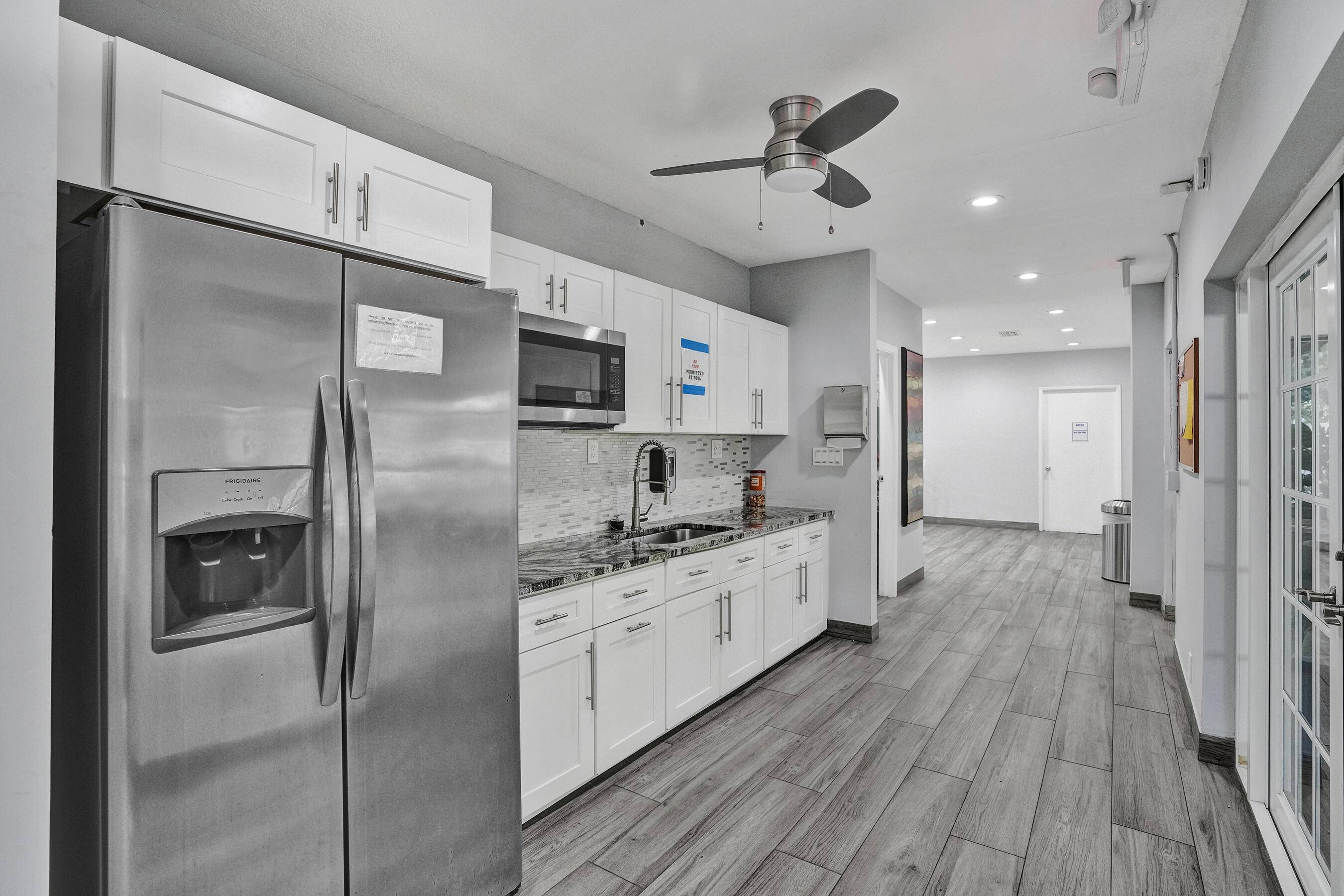 3520 Oaks Way, Unit 1010 Pompano Beach, FL 33069 - Photo 61 of 67 a kitchen with stainless steel appliances a refrigerator sink and microwave