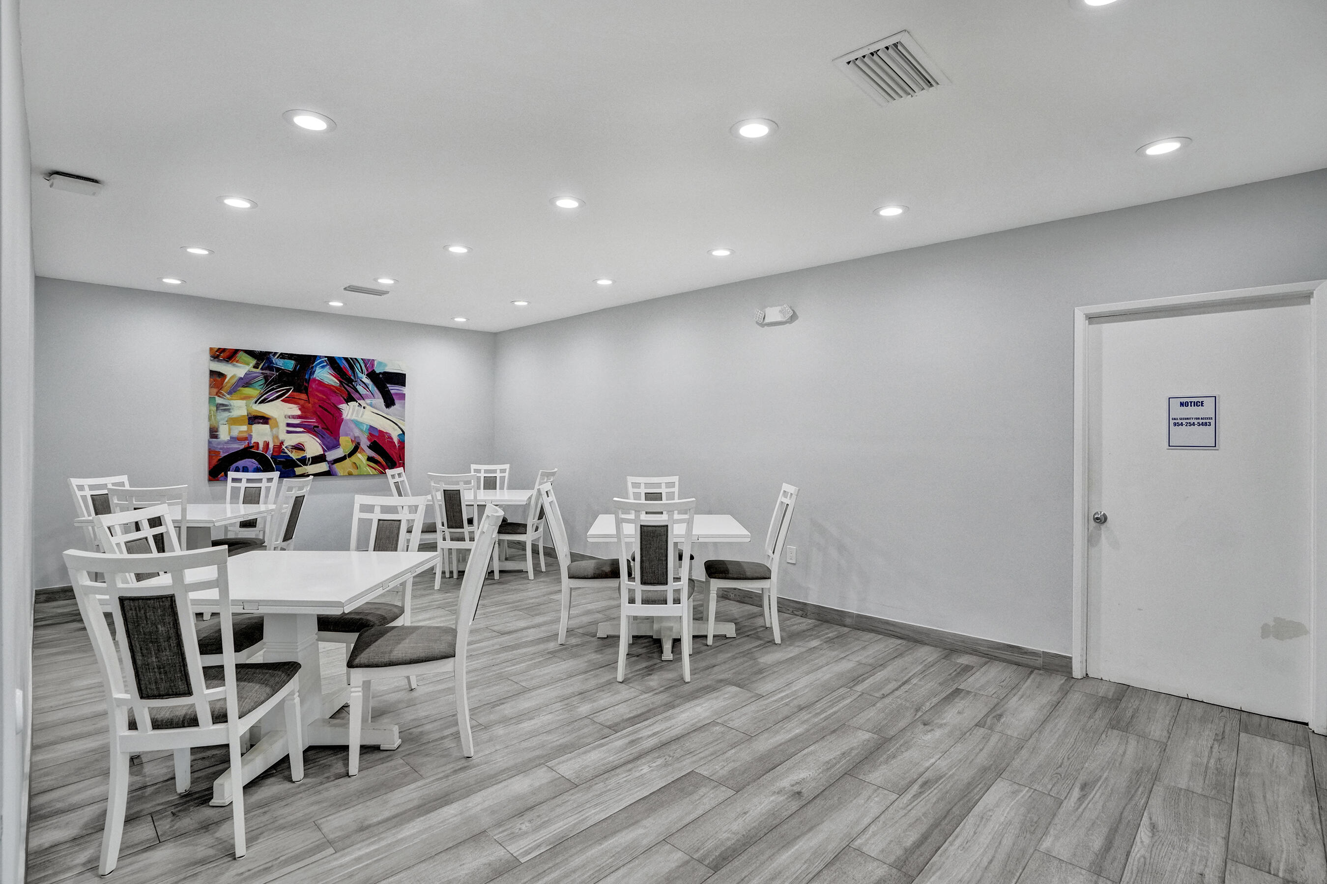 3520 Oaks Way, Unit 1010 Pompano Beach, FL 33069 - Photo 62 of 67 a view of a dining room with furniture wooden floor and chandelier