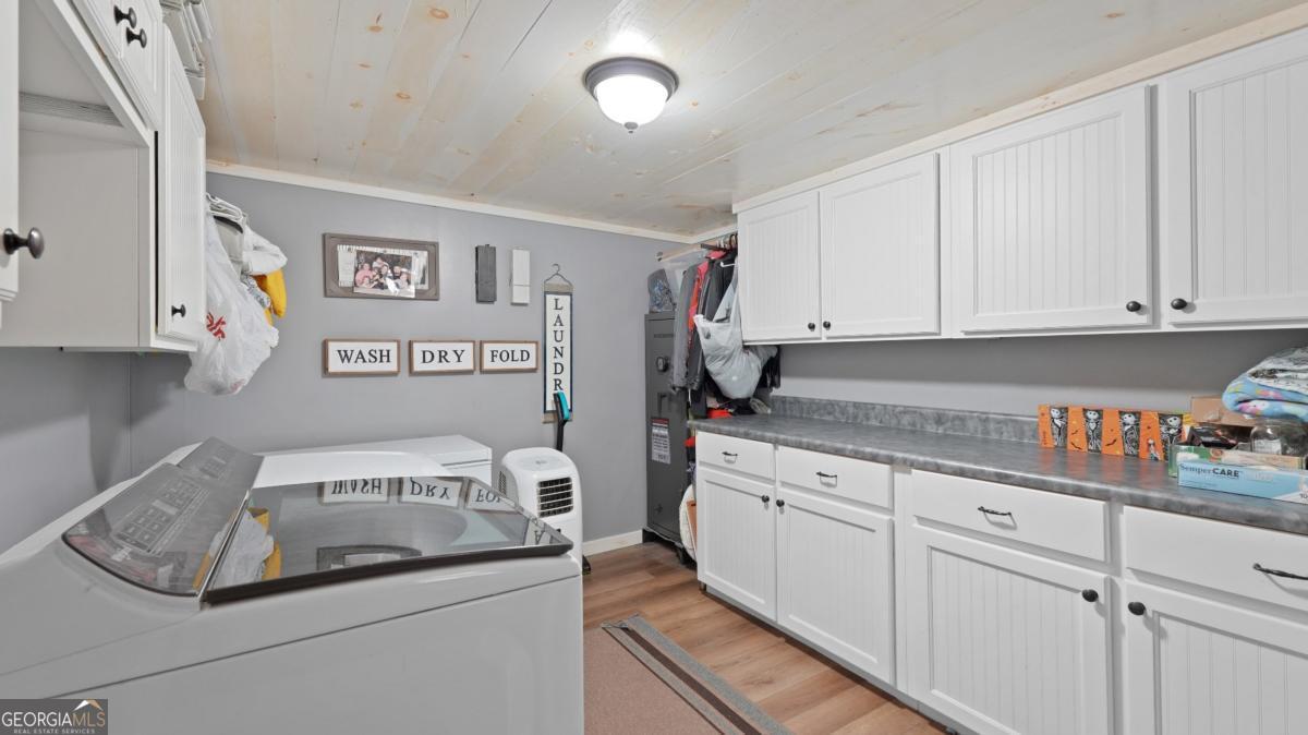4866 Kville Road Screven, GA 31560 - Photo 22 of 39 a kitchen with stainless steel appliances granite countertop a sink and cabinets