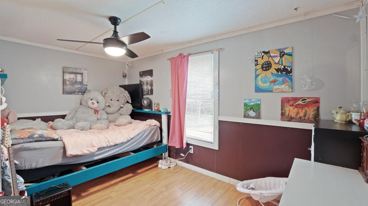 4866 Kville Road Screven, GA 31560 - Photo 34 of 39 a bedroom with a bed and a chandelier