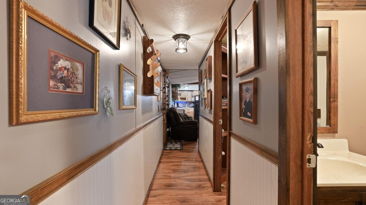 4866 Kville Road Screven, GA 31560 - Photo 36 of 39 a view of a hallway with wooden floor