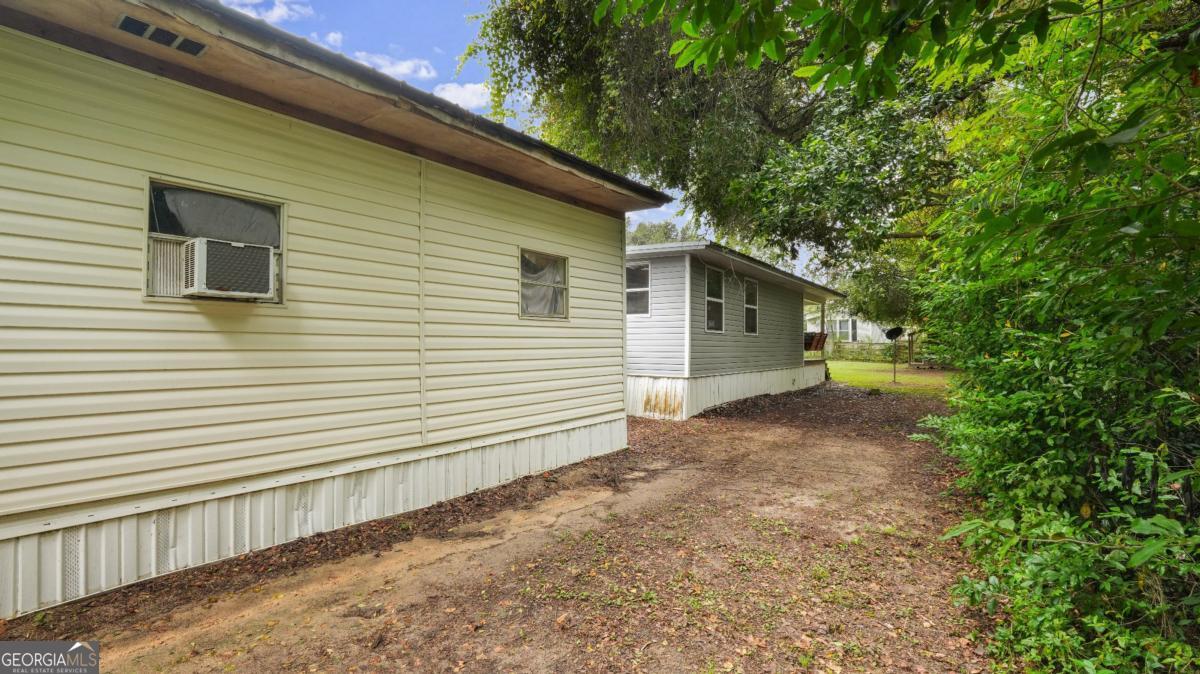 4866 Kville Road Screven, GA 31560 - Photo 7 of 39 a view of a house with a backyard