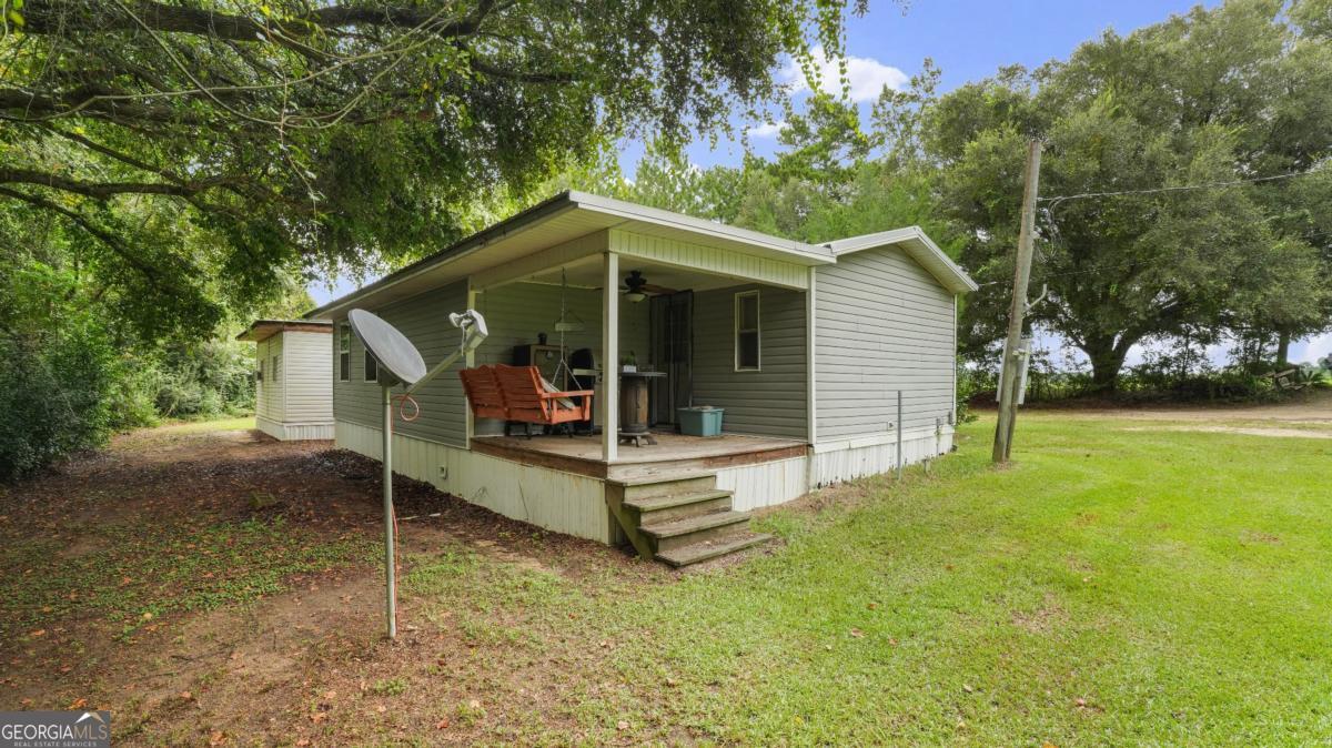4866 Kville Road Screven, GA 31560 - Photo 9 of 39 a view of a house with a yard