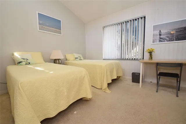 a spacious bedroom with a bed and window