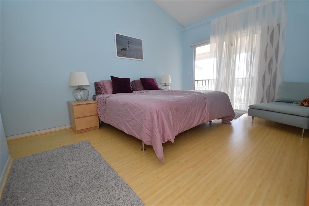 1512 Pelican Point Drive, Unit BA264 Sarasota, FL 34231 - Photo 17 of 44 a spacious bedroom with a bed and window