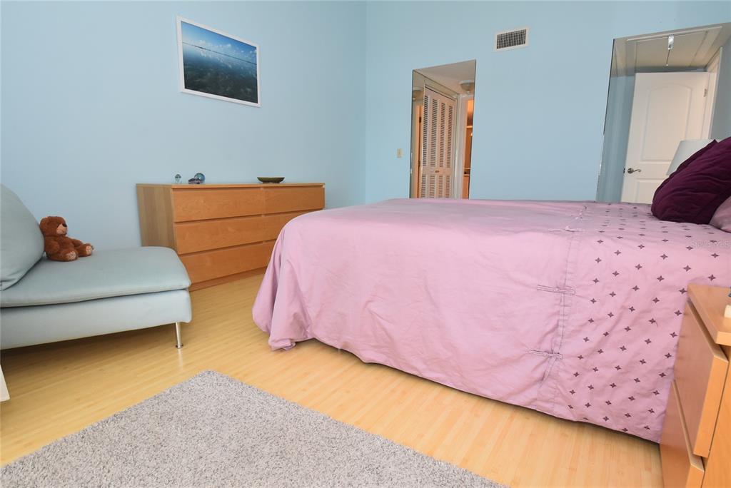 1512 Pelican Point Drive, Unit BA264 Sarasota, FL 34231 - Photo 18 of 44 a bedroom with a bed and a flat screen tv