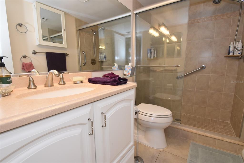 1512 Pelican Point Drive, Unit BA264 Sarasota, FL 34231 - Photo 19 of 44 a bathroom with a sink a toilet and shower