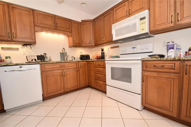 a kitchen with stainless steel appliances granite countertop a refrigerator sink and cabinets