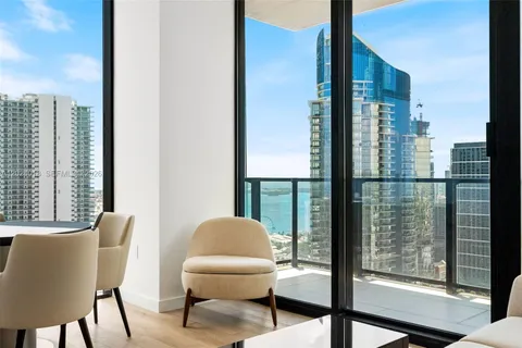 a balcony view with a large window and city view