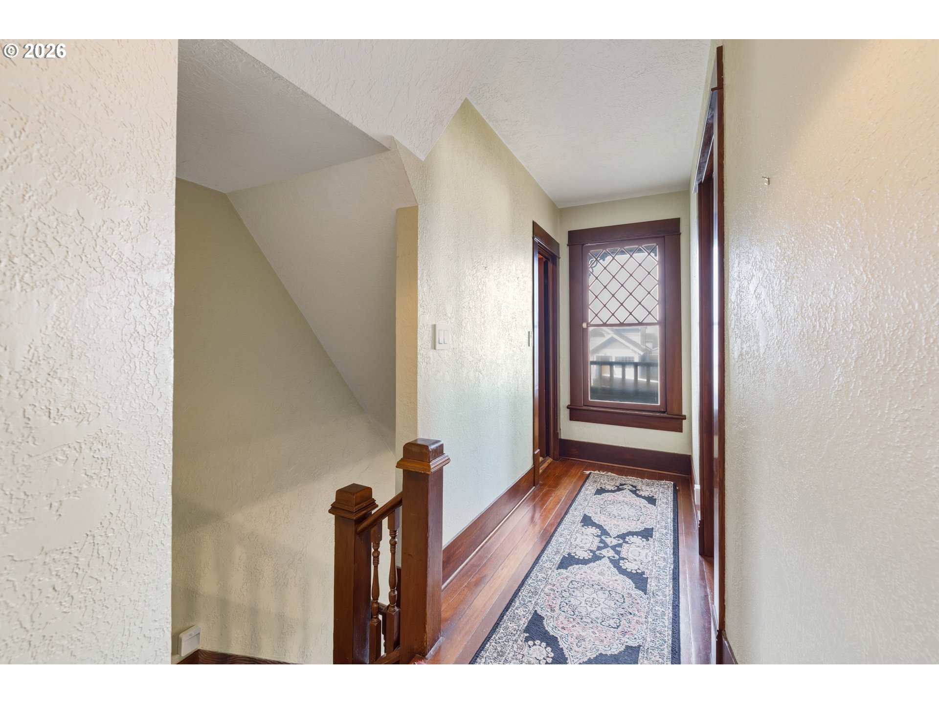 2139 McPherson Avenue North Bend, OR 97459 - Photo 21 of 35 a view of a hallway with wooden floor and a living room