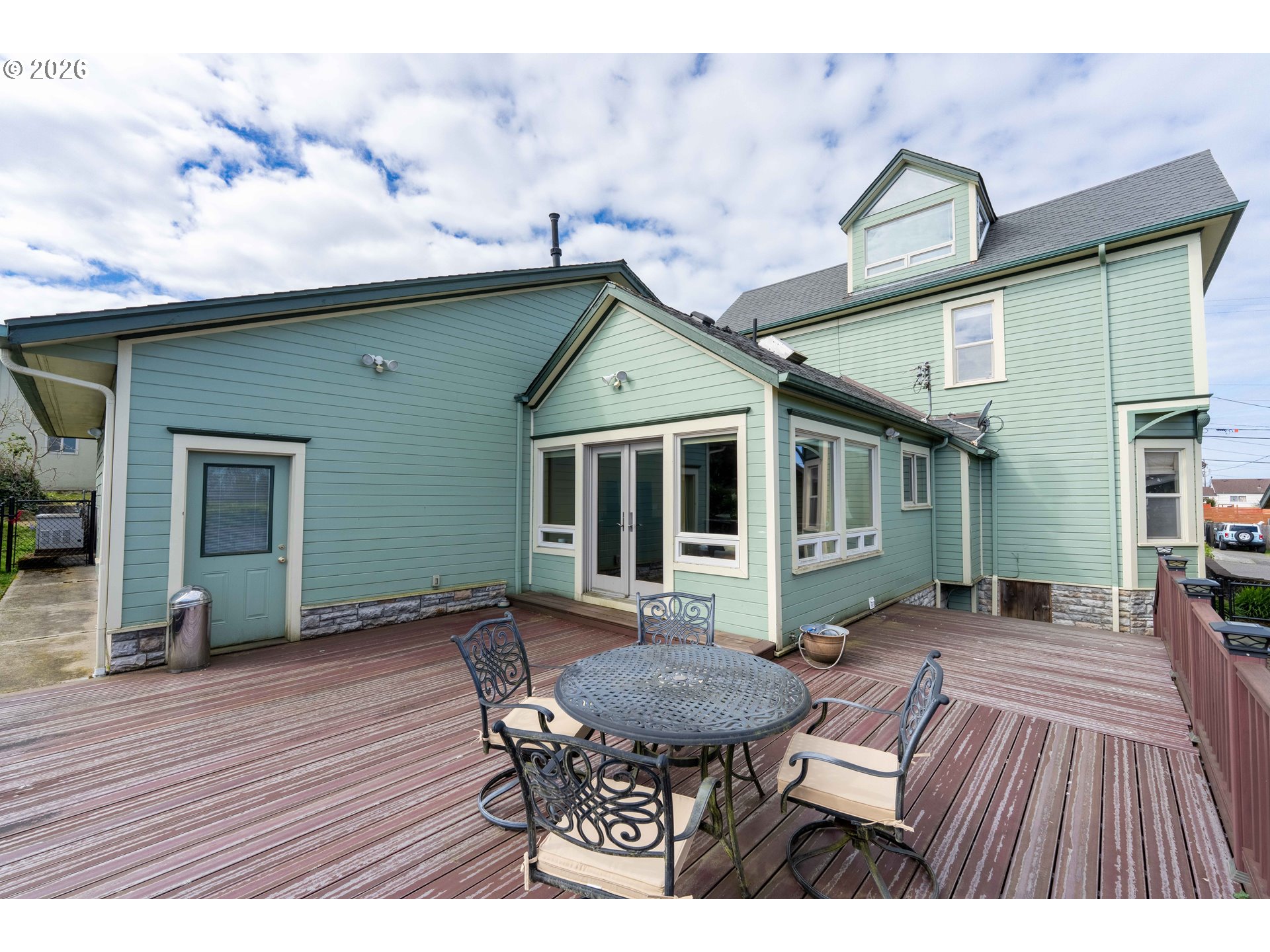 2139 McPherson Avenue North Bend, OR 97459 - Photo 29 of 35 a view of a house with a chairs and table in a patio