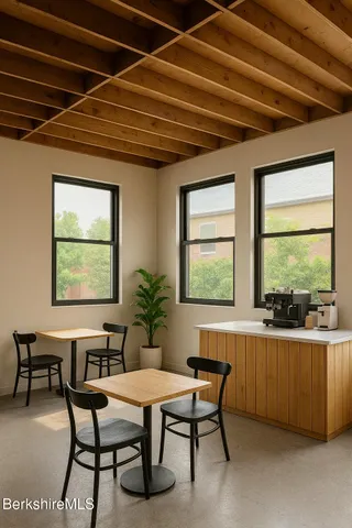 a dining room with furniture and a floor to ceiling window