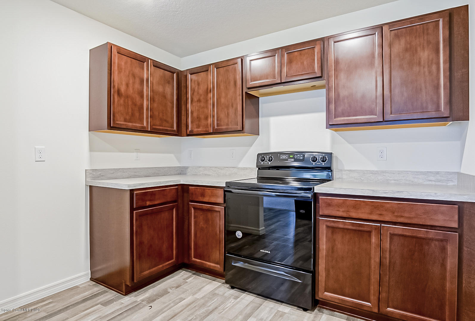 1237 Haulover Road Southwest Palm Bay, FL 32908 - Photo 3 of 15 a kitchen with granite countertop wooden cabinets and a stove top oven