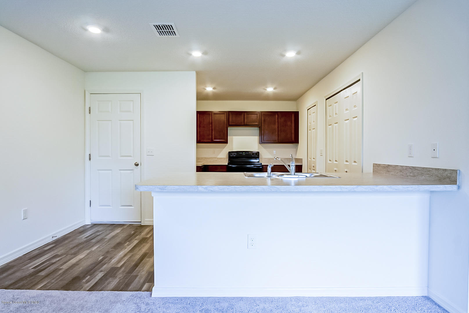 1237 Haulover Road Southwest Palm Bay, FL 32908 - Photo 4 of 15 a view of kitchen with wooden floor
