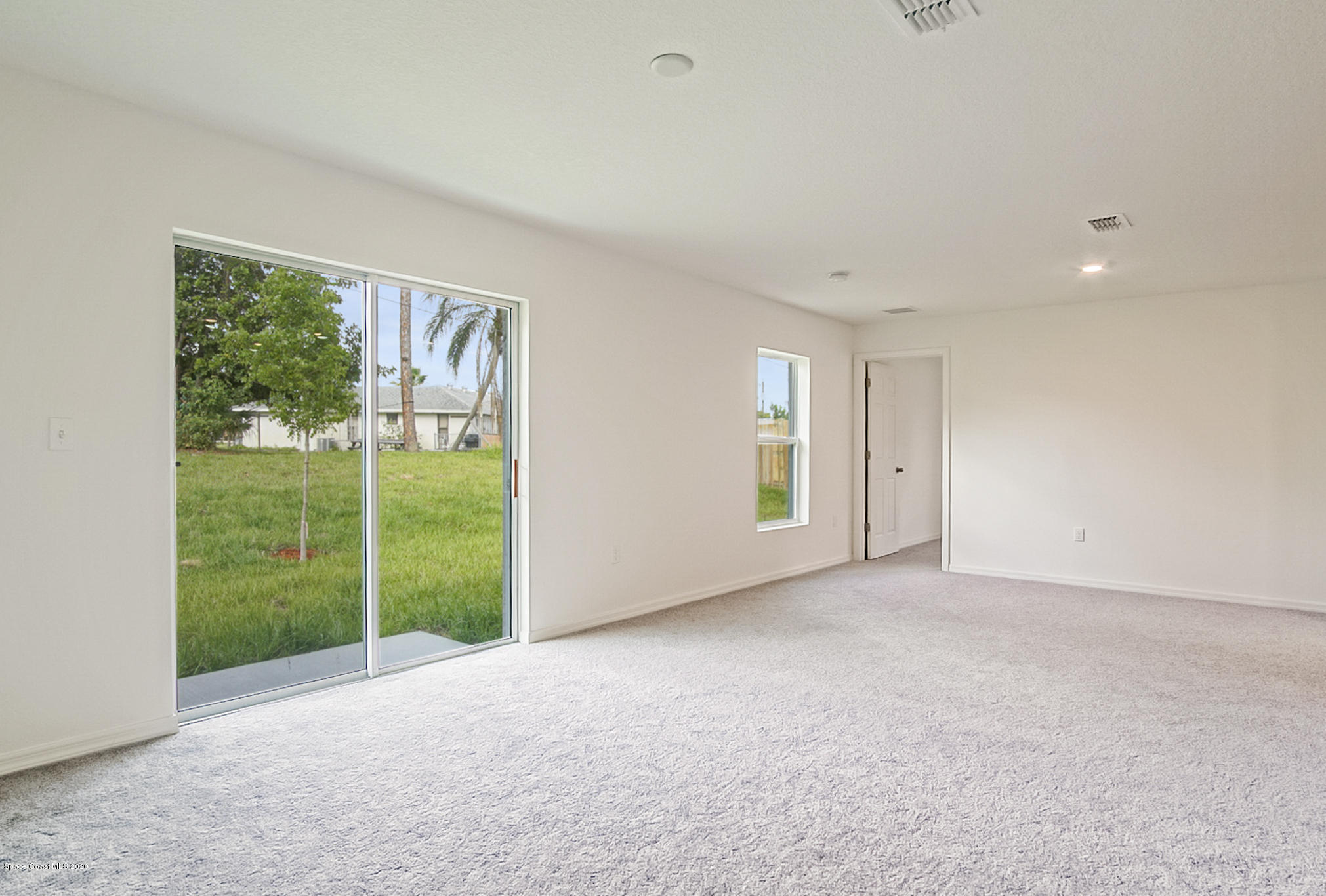 1237 Haulover Road Southwest Palm Bay, FL 32908 - Photo 5 of 15 a view of an empty room with wooden floor and windows