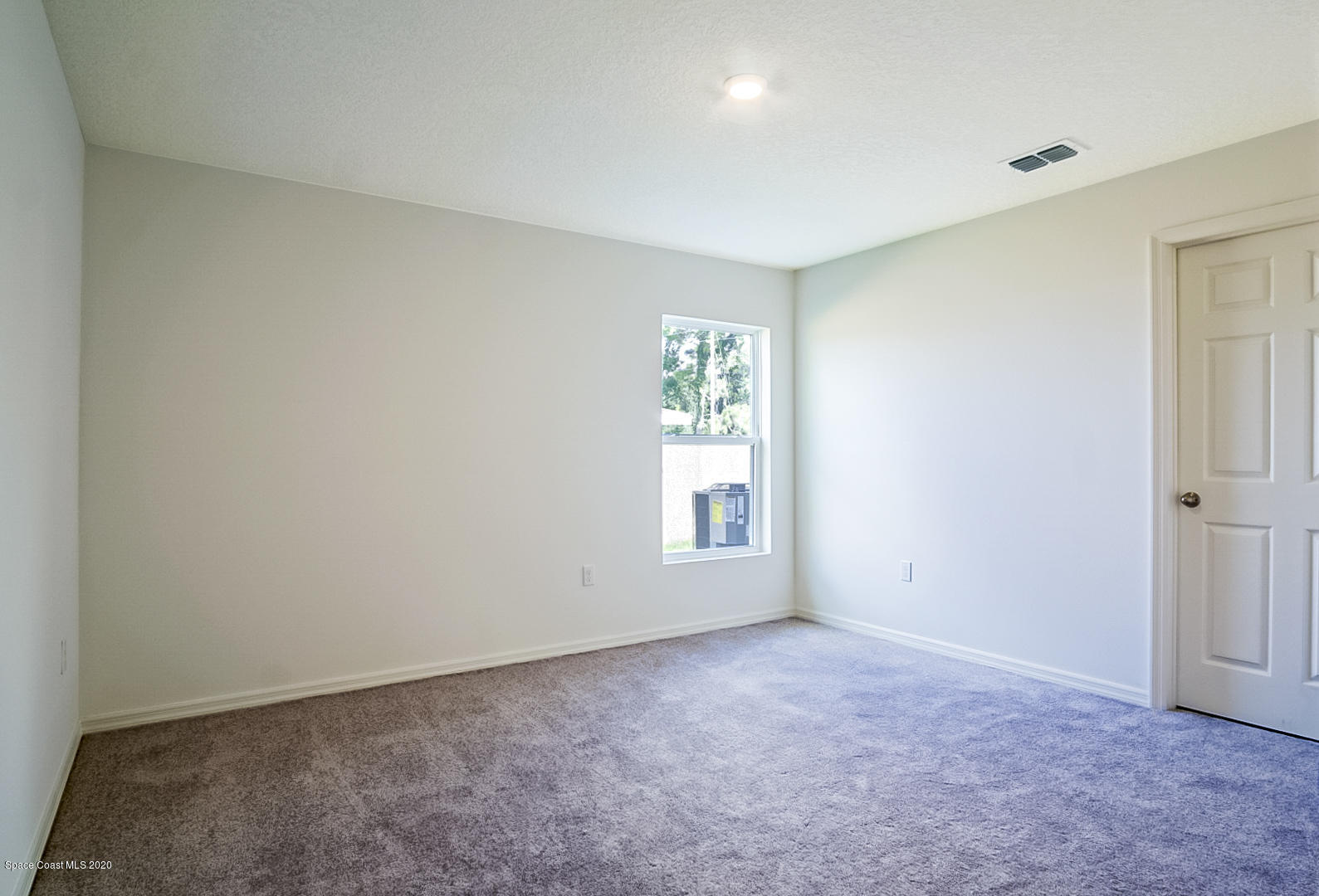 1237 Haulover Road Southwest Palm Bay, FL 32908 - Photo 6 of 15 an empty room with windows