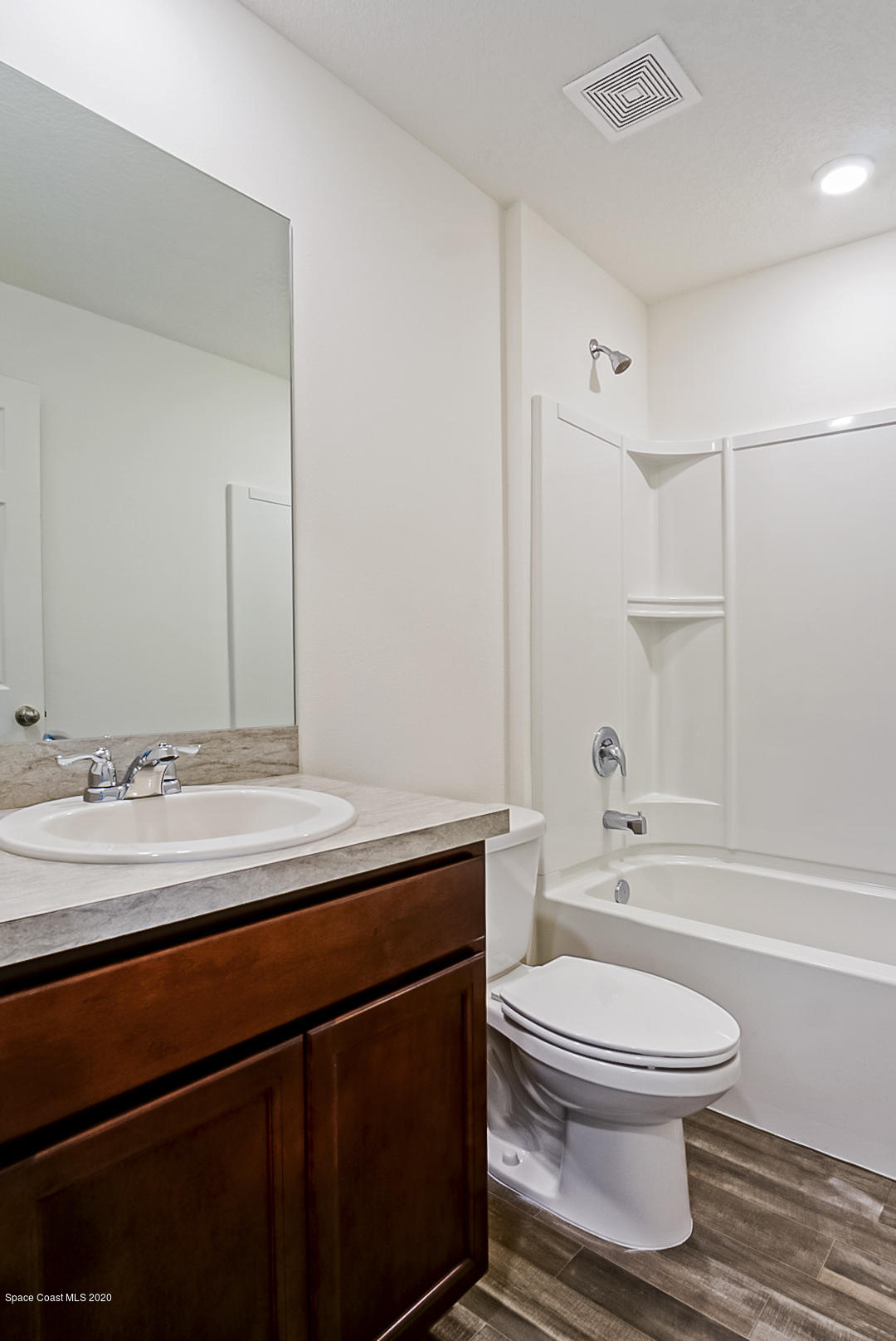 1237 Haulover Road Southwest Palm Bay, FL 32908 - Photo 10 of 15 a bathroom with a sink a toilet and a mirror