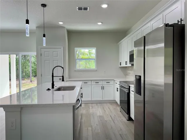 a view of a room with wooden floor and white walls