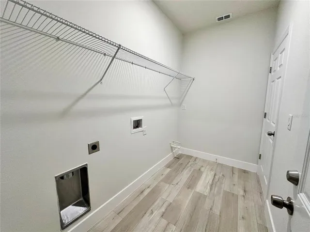 a view of a room with wooden floor
