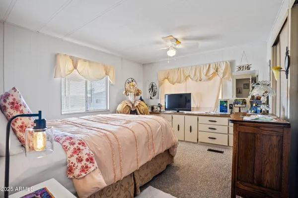 a bedroom with bed and windows