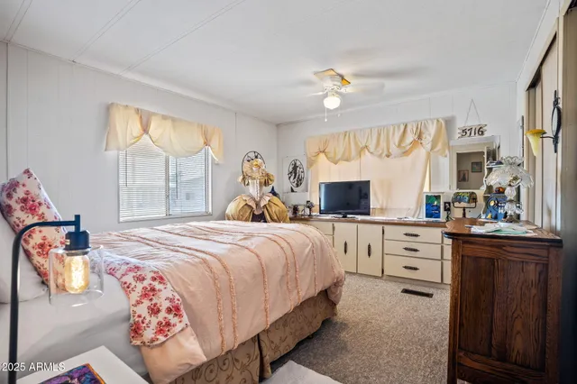 a bedroom with bed and windows