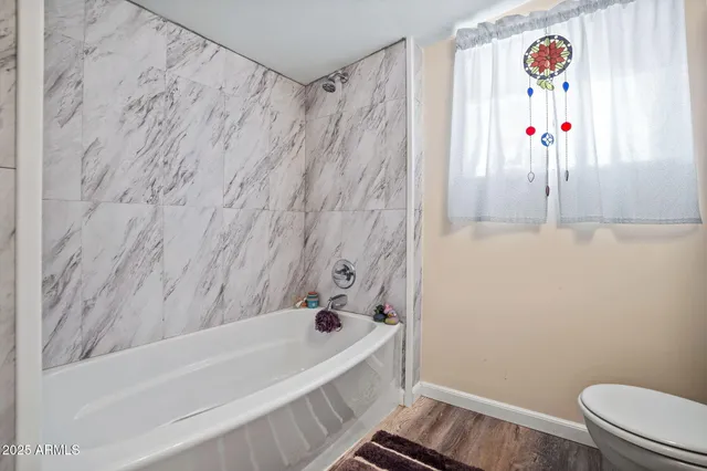 a utility room with dryer washer and a view of living room