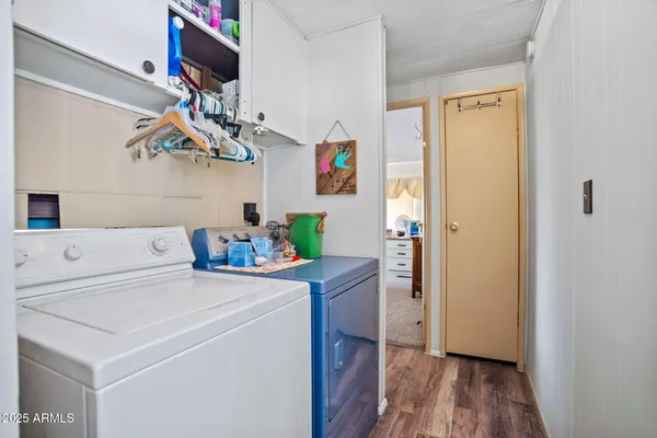 a dining room with furniture a chandelier and wooden floor