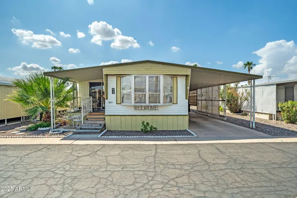 a street sign on a sidewalk next to a road