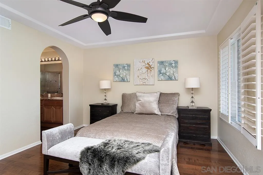 2230 Historic Decatur Road, Unit 63 San Diego, CA 92106 - Photo 11 of 25 a bedroom with a bed and wooden floor