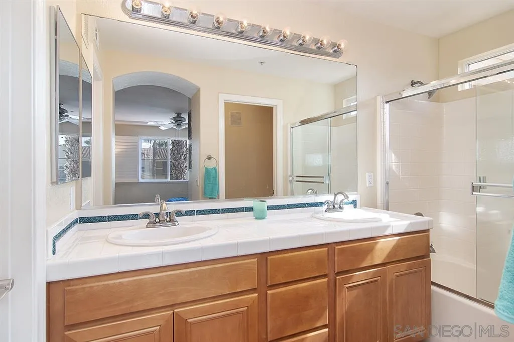 2230 Historic Decatur Road, Unit 63 San Diego, CA 92106 - Photo 14 of 25 a bathroom with a sink and a mirror